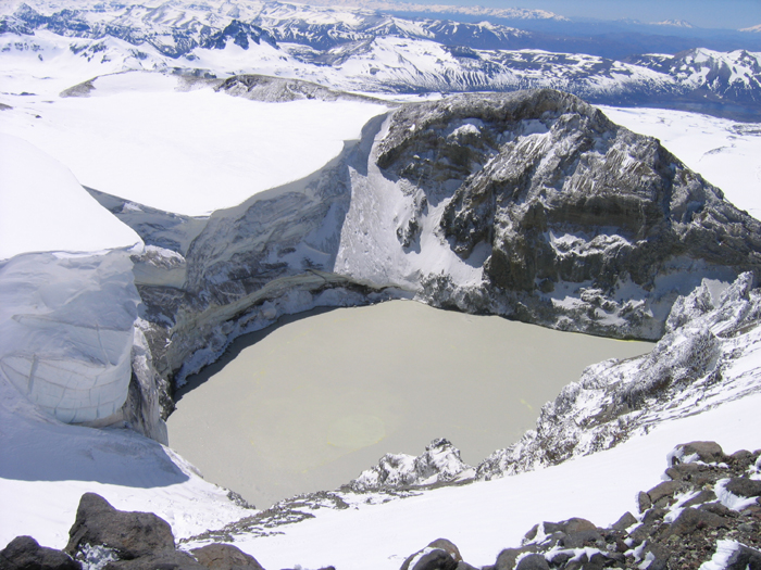 The spectacular crater on the east side fo Copahue. The lake is full of sulphur and steams away, 
the ice cliff at the edge of the glacier is ove 100m high and overhangs by about 10?.